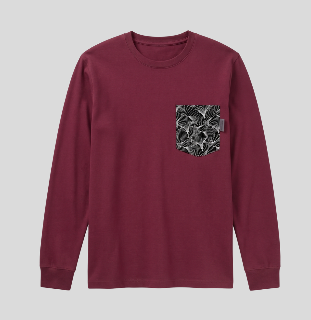 A long-sleeve crewneck shirt in burgundy, featuring a black and white patterned pocket on the left chest, displayed against a solid light gray background.