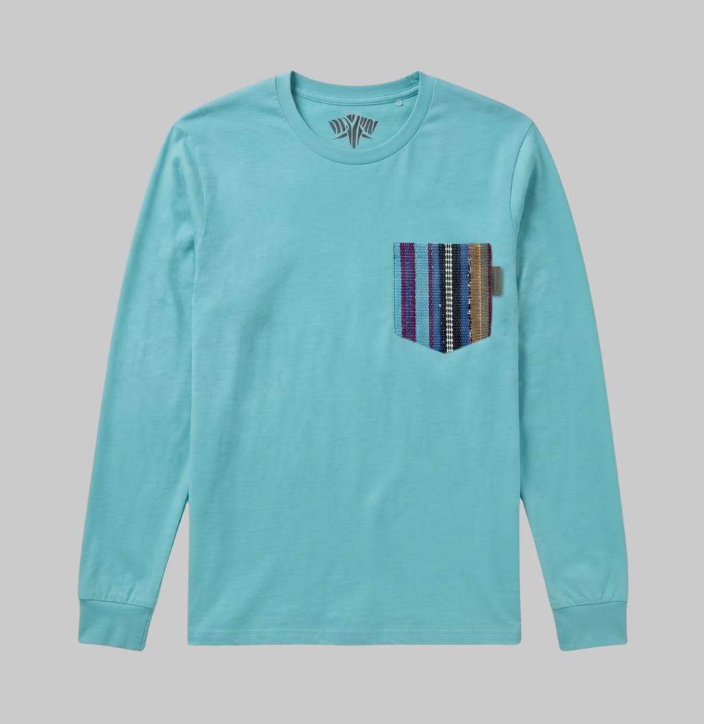 A light turquoise long-sleeve crewneck shirt with a vertical striped patch pocket on the left chest, featuring purple, blue, white, and brown stripes, shown against a solid gray background.