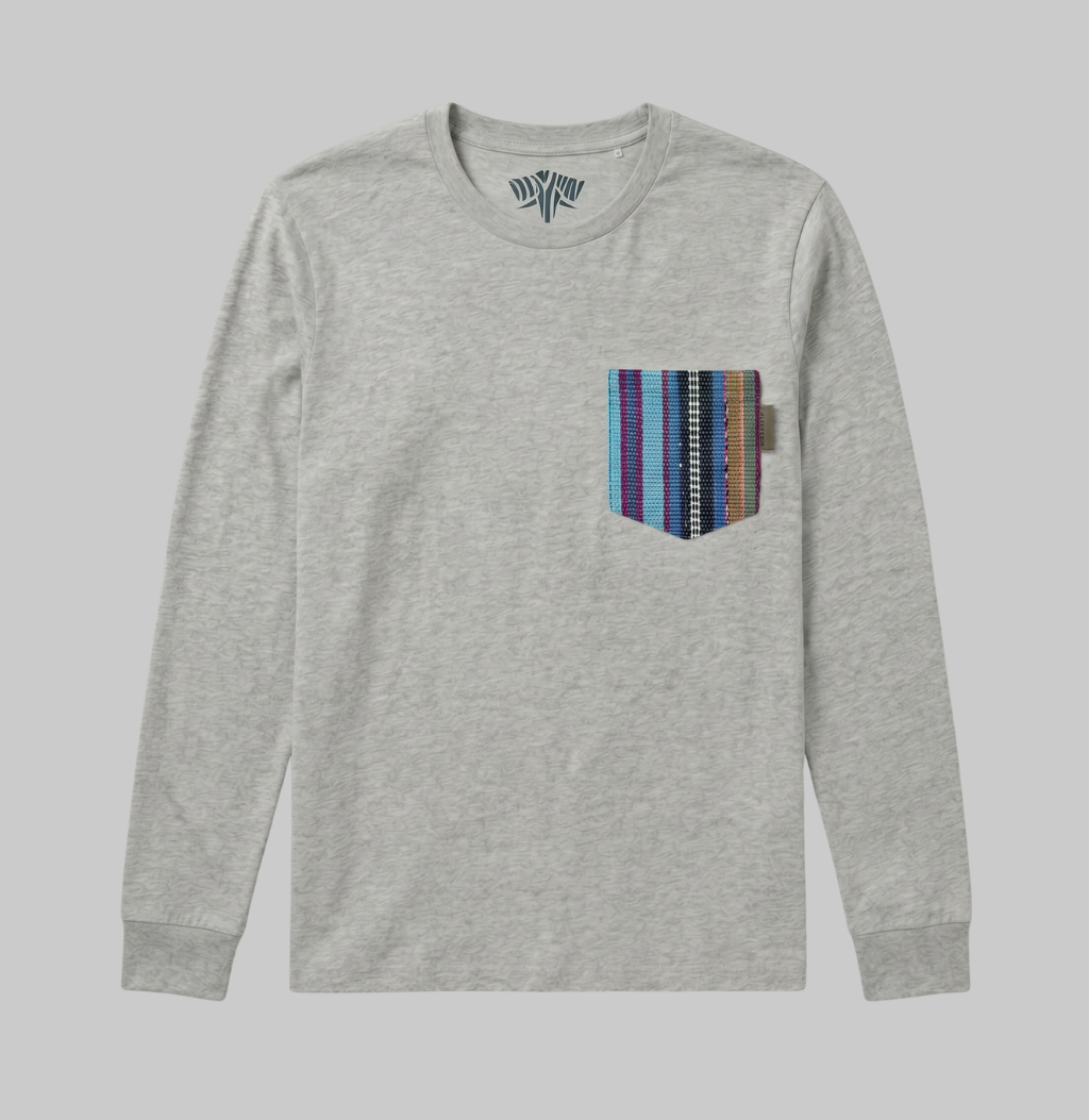 A light heather gray long-sleeve crewneck shirt with a multi-colored striped pocket on the left chest, displayed against a solid gray background.