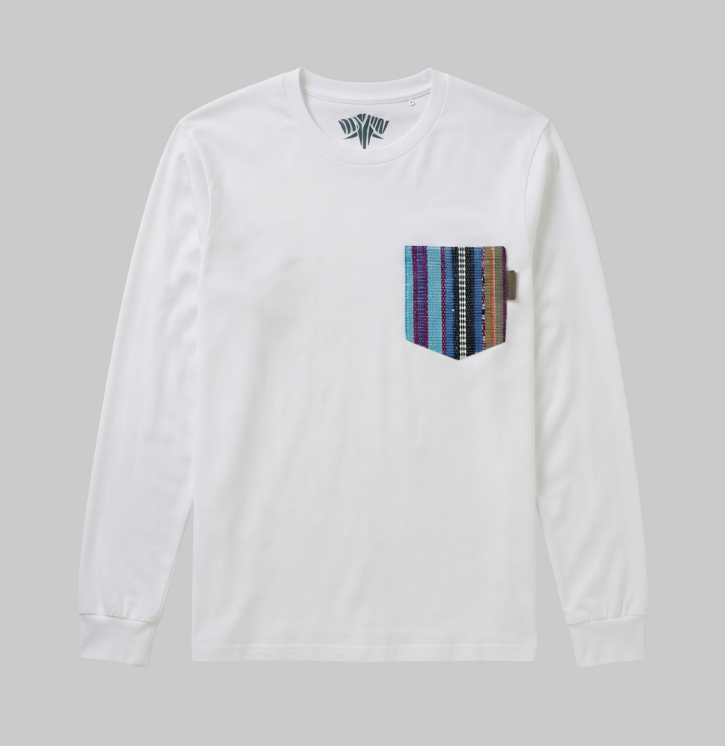 A white long-sleeve crewneck t-shirt with a multi-colored striped woven pocket on the left chest, displayed against a solid gray background.