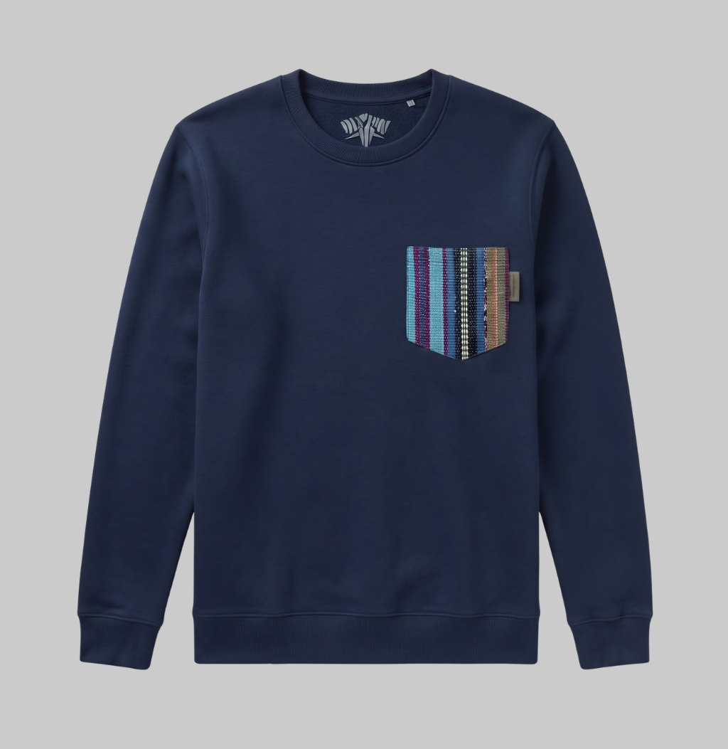 A navy blue crewneck sweatshirt with a decorative multi-colored striped pocket on the left chest, shown against a solid gray background.
