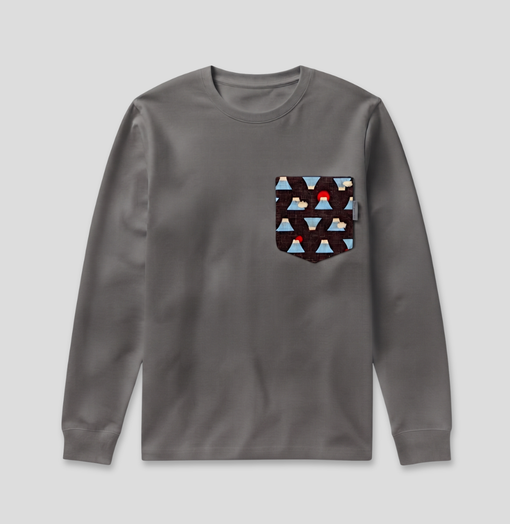 A dark gray long-sleeve crewneck shirt with a patterned chest pocket featuring geometric triangles in blue, brown, and white with a small red accent.