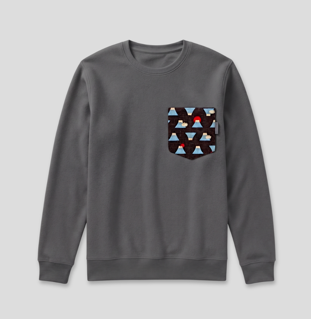 A dark gray crewneck sweatshirt with a chest pocket featuring a geometric triangle pattern in black, light blue, and red, shown against a light gray background.