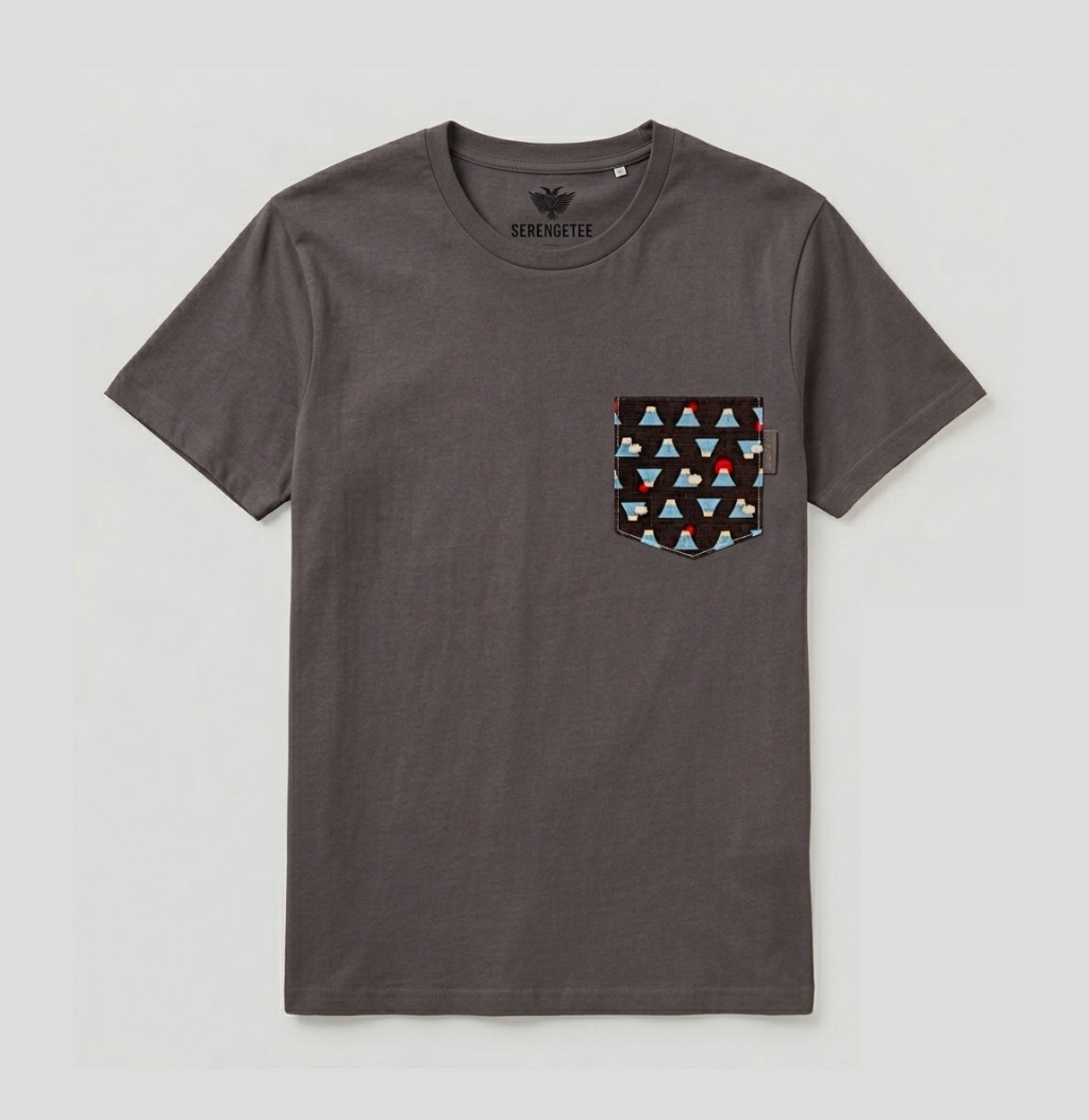 A dark gray crewneck t-shirt with a patterned chest pocket featuring triangles in red, light blue, and black. The brand name 'SERENATEE' is printed inside the collar.