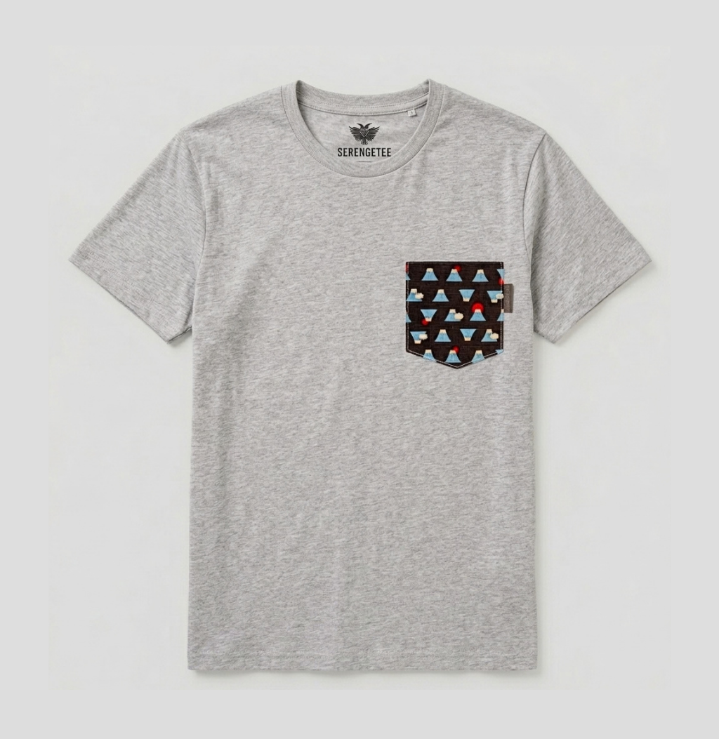 A heather gray short-sleeve t-shirt with a geometric patterned chest pocket. The pocket features a black background with repeating triangles in light blue, red, and dark gray.