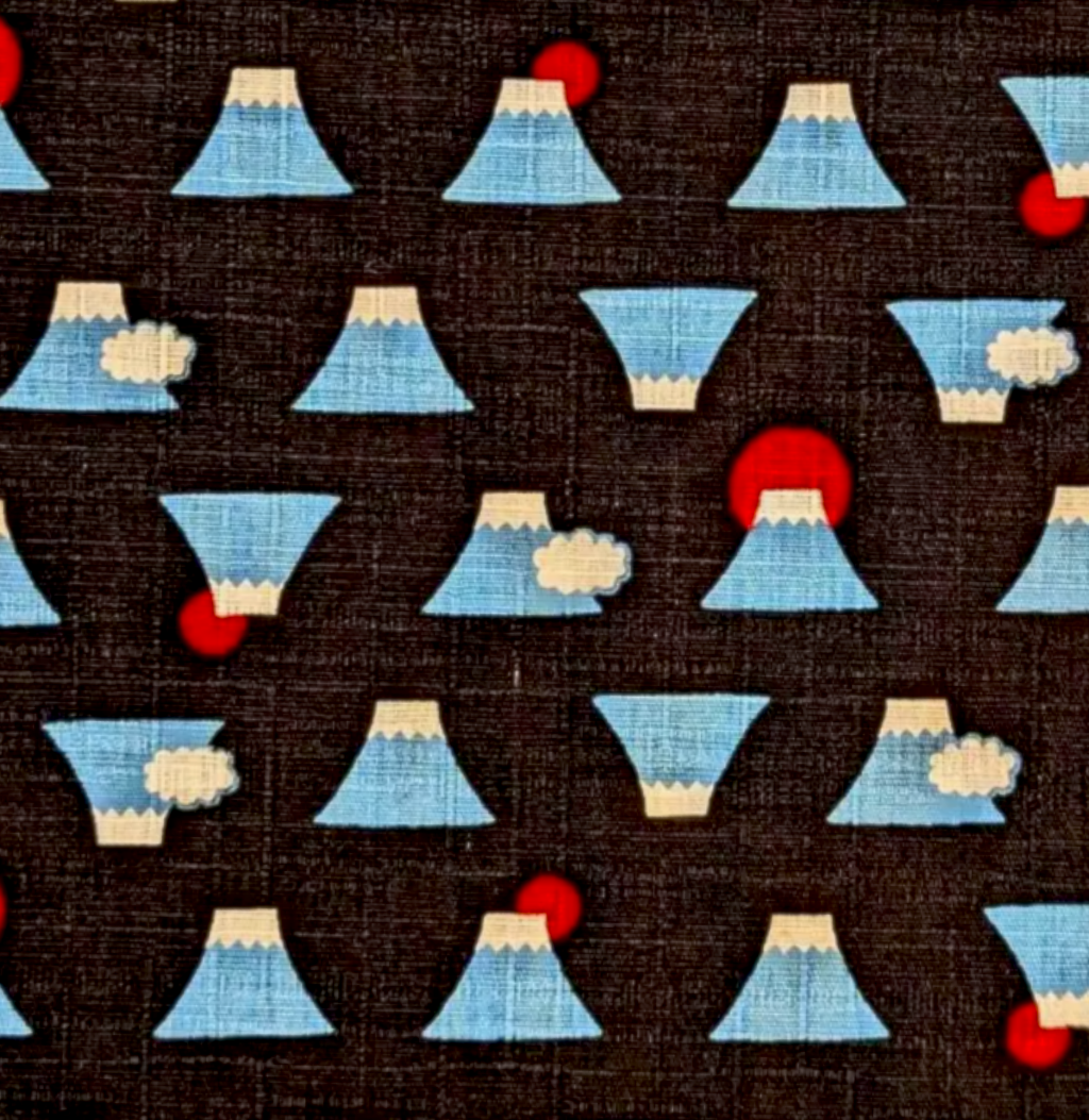 A close-up of a dark brown fabric with a repeating pattern of light blue and white mountain motifs accented with small red circles.