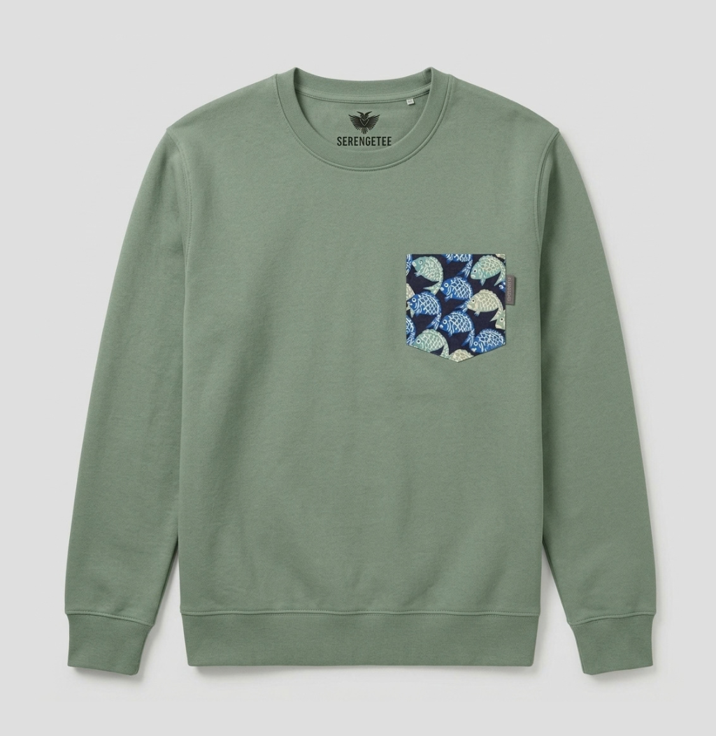 A sage green crewneck sweatshirt by Sermentaux, featuring a patterned chest pocket with blue and white seigaiah (paper umbrella) motifs on a dark navy background.