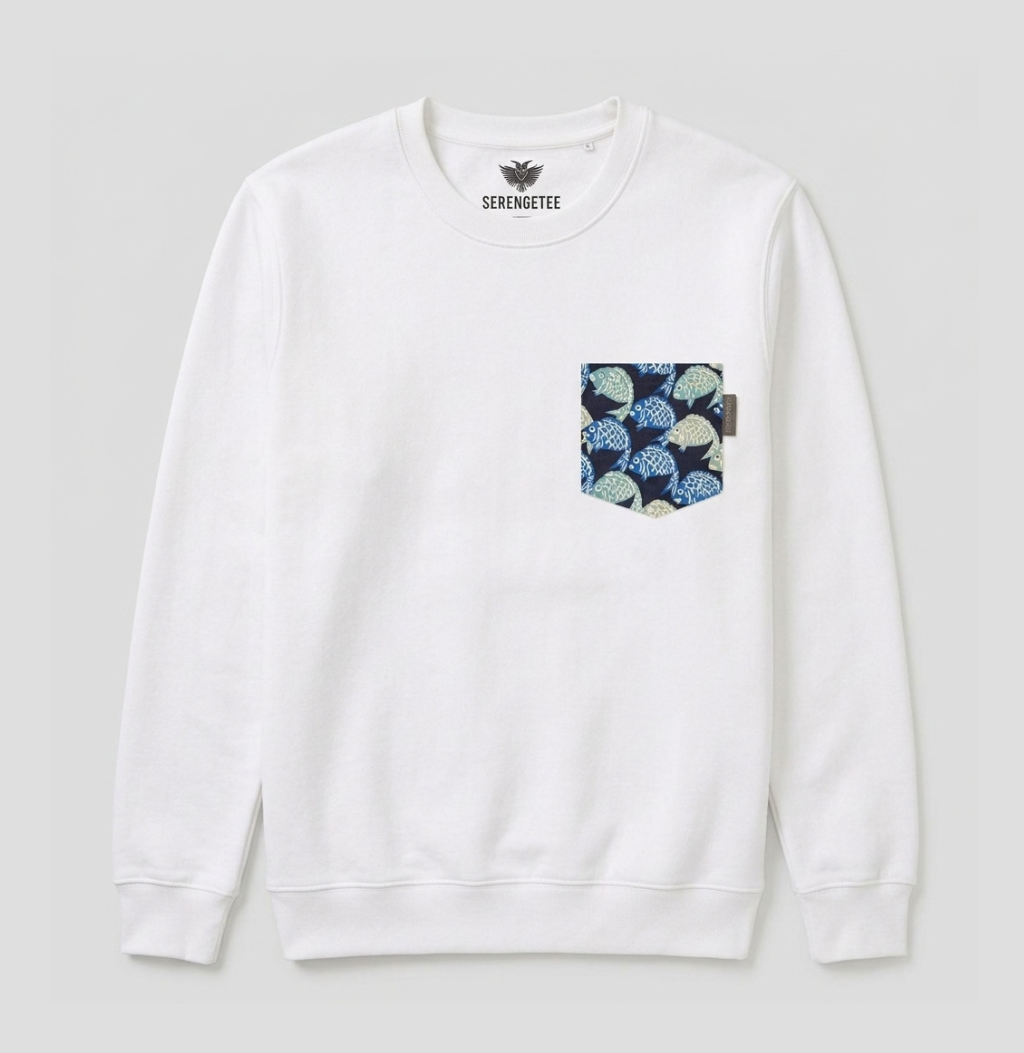 A white crewneck sweatshirt with a chest pocket featuring a blue and green pattern, shown against a light gray background. The brand name 'SERENGETEE' is printed inside the collar.