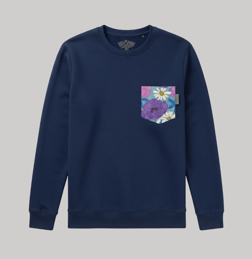 A navy blue crewneck sweatshirt with a front chest pocket featuring a colorful floral print with purple flowers and white daisies on a light blue background.