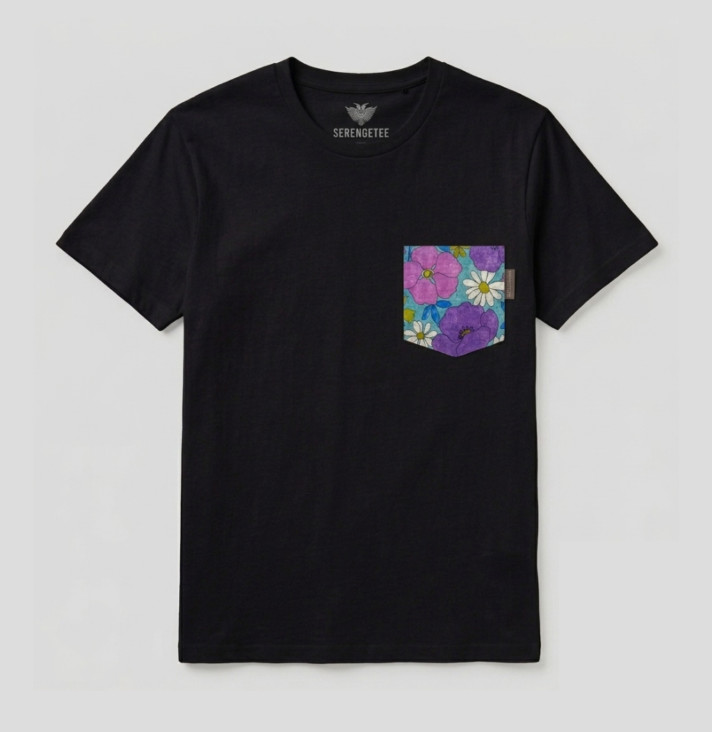 A black short-sleeve pocket t-shirt by Serenmeste, featuring a colorful floral print pocket on the left chest with pink, purple, and white flowers, displayed on a light gray background.