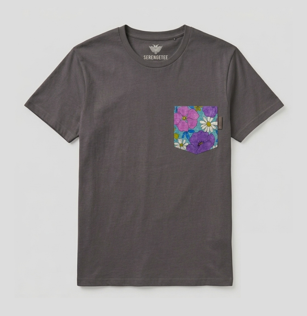 A dark gray crewneck t-shirt by Serengette, featuring a front chest pocket decorated with a colorful floral print of pink, purple, and white flowers.