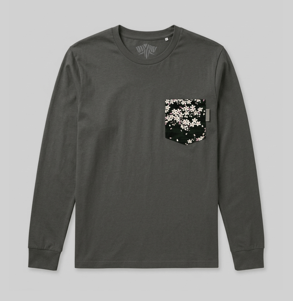 A dark gray long-sleeve crewneck shirt with a chest pocket featuring a black background and a white cherry blossom pattern, displayed flat against a light gray background.