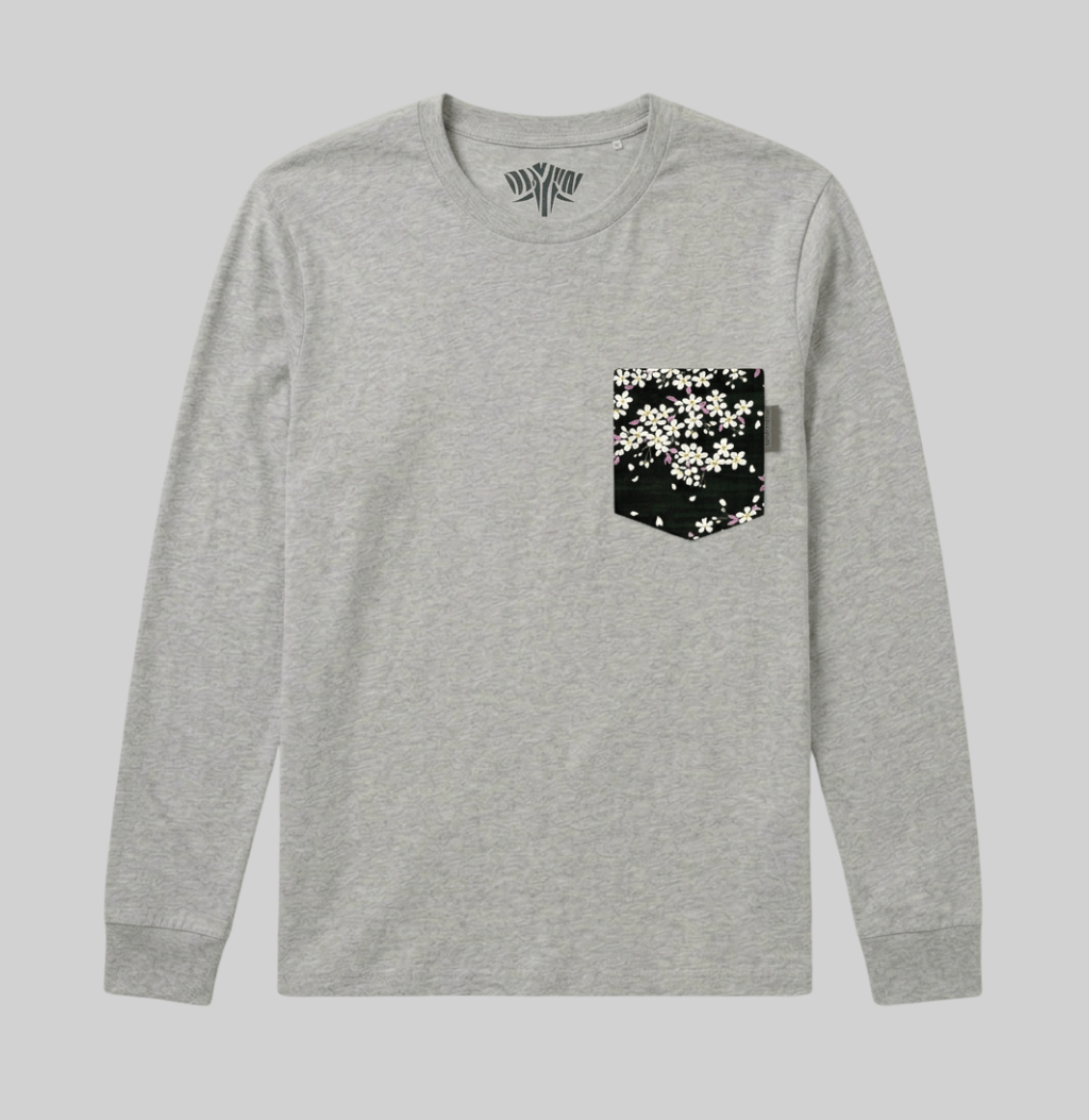 A light heather gray long-sleeve t-shirt with a black chest pocket featuring a white cherry blossom pattern, shown against a solid gray background.