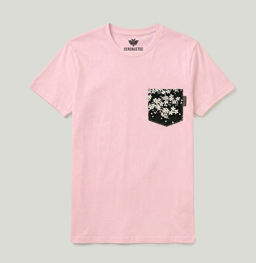 A light pink short-sleeve crewneck t-shirt by SevernTree, featuring a black pocket on the left chest decorated with a white floral pattern.