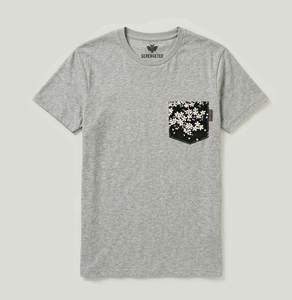 A heather gray crewneck t-shirt with a black chest pocket featuring a white floral pattern, shown flat on a light gray background. The brand name 'SILVEROUTEE' is printed inside the collar.