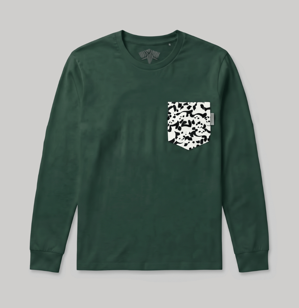A dark green long-sleeve crewneck shirt with a white and black camouflage patterned chest pocket, displayed flat against a neutral gray background.
