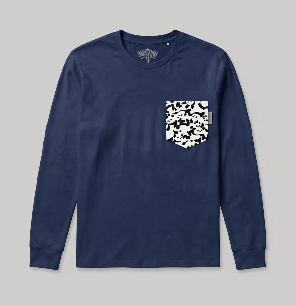 A navy blue long-sleeve crewneck shirt with a white and black camouflage patterned chest pocket, displayed flat against a neutral gray background.