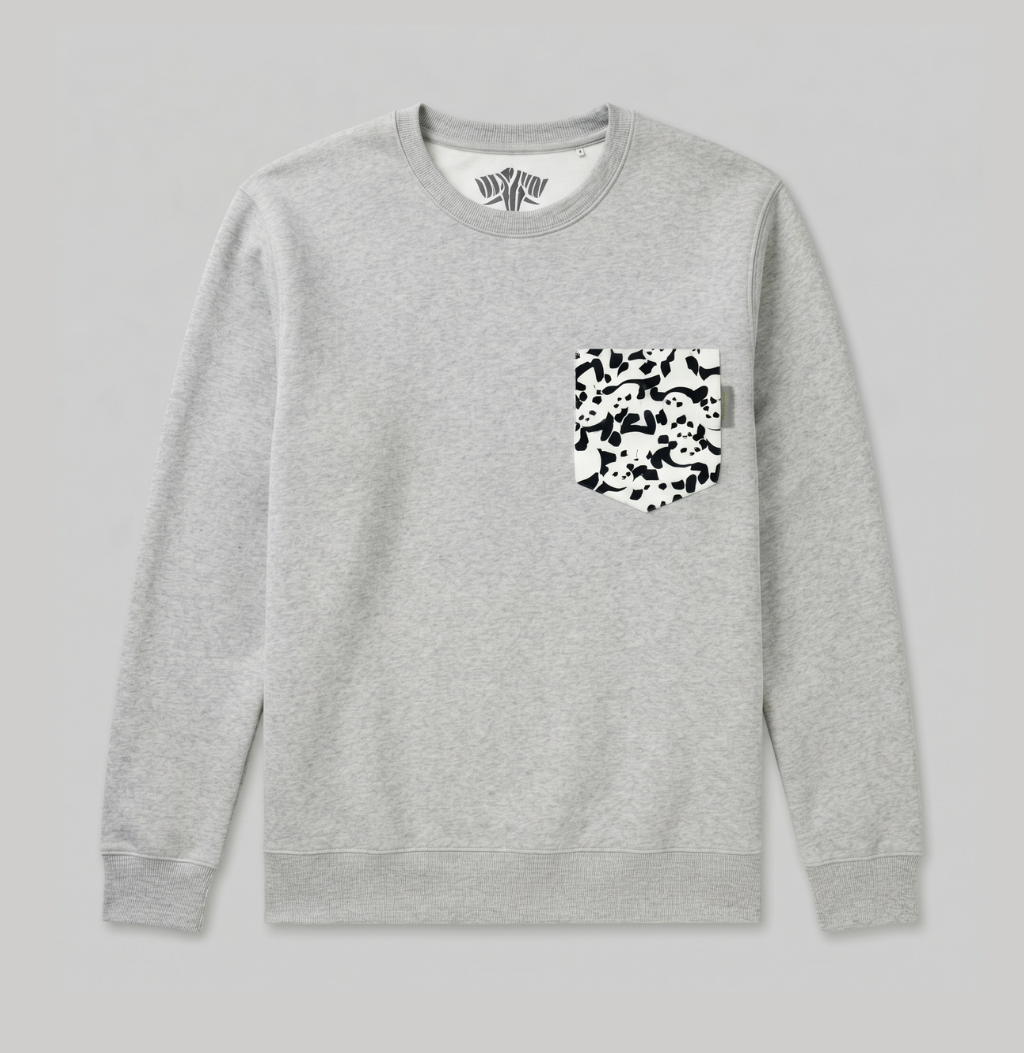 A light gray crewneck sweatshirt with a black and white camouflage patterned chest pocket, shown flat against a light gray background.