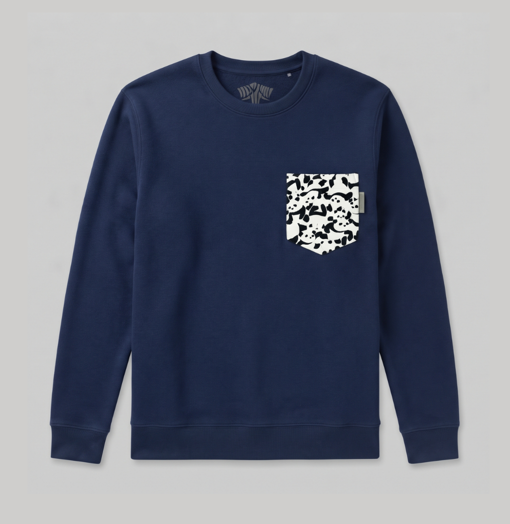 A navy blue crewneck sweatshirt with a white and black camouflage patterned chest pocket, displayed flat against a light gray background.