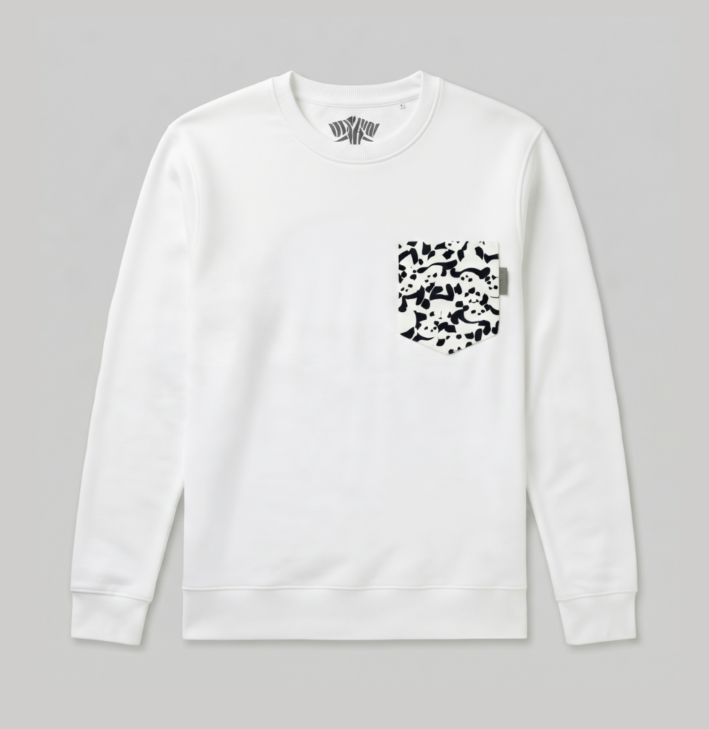 A white crewneck sweatshirt with a black-and-white abstract patterned chest pocket, displayed flat against a neutral gray background.