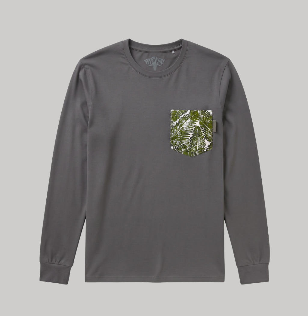 A dark gray long-sleeve t-shirt with a green and white tropical leaf pattern pocket on the left chest, displayed against a solid gray background.