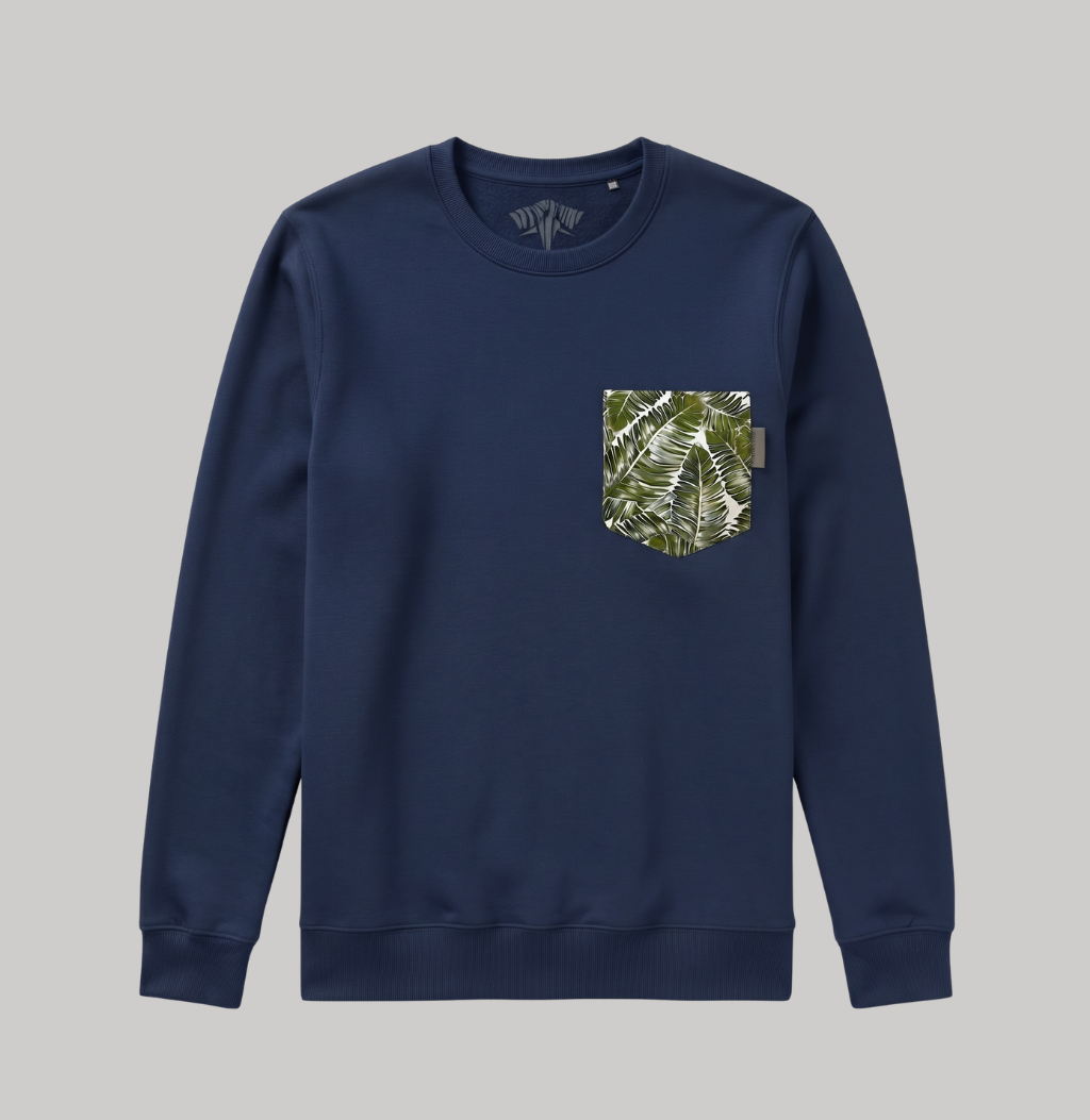 A navy blue crewneck sweatshirt with a chest pocket featuring a green and white tropical leaf pattern, displayed on a solid gray background.