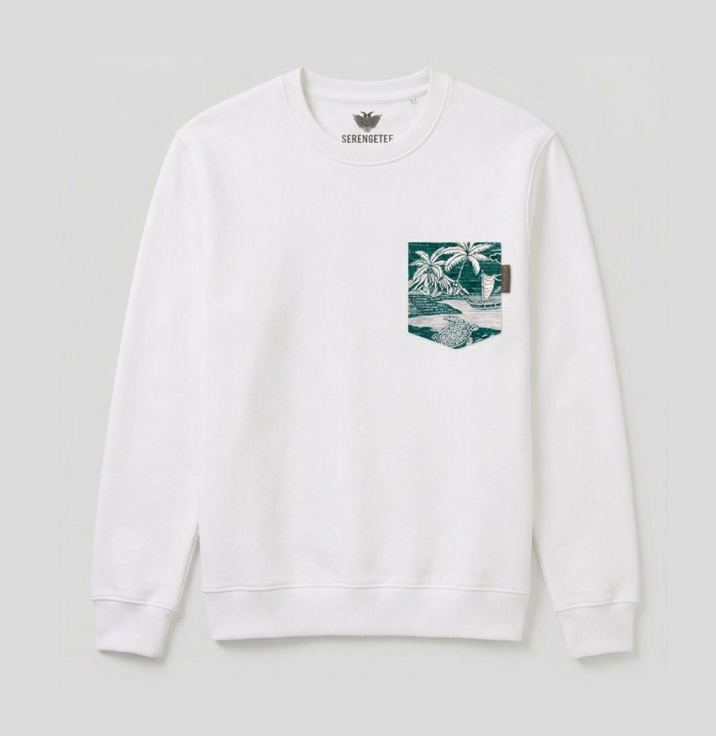 A white long-sleeve crewneck sweatshirt by Serenitifi, featuring a graphic print on the left chest pocket depicting a tropical beach scene with palm trees and a wave.