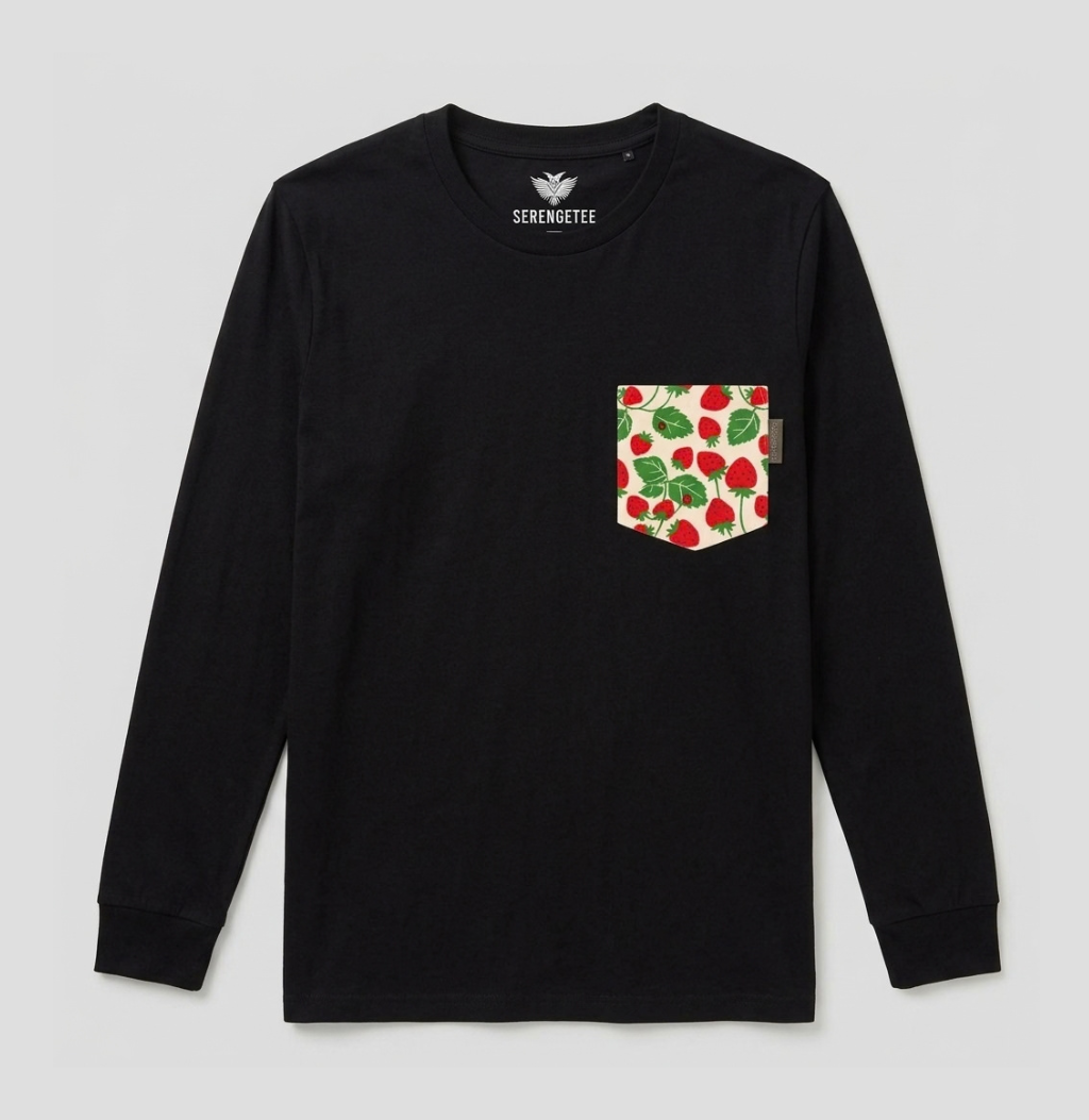 A black long-sleeve crewneck shirt by Serenoute, featuring a chest pocket with a red and green strawberry pattern on a cream background.