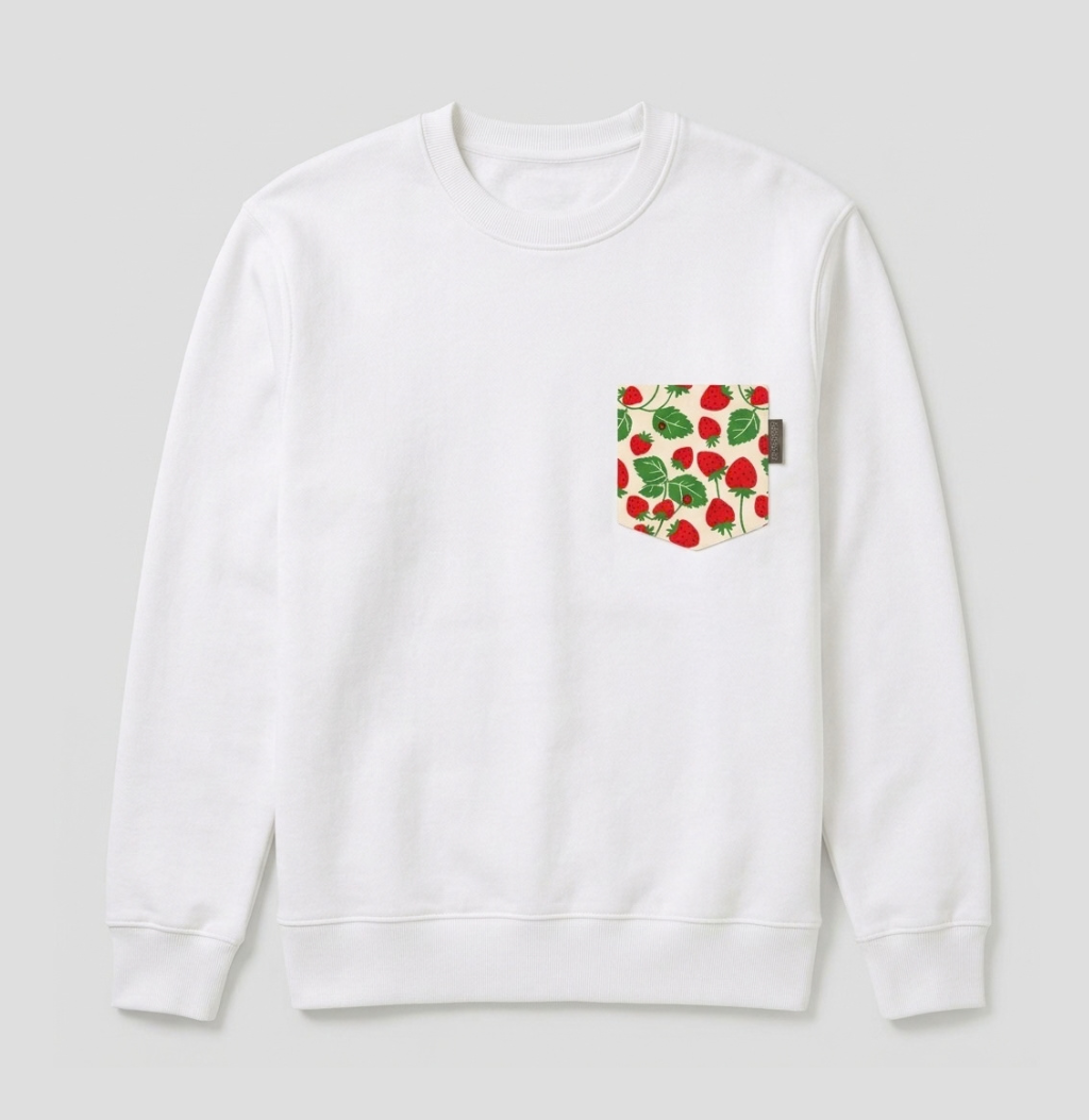A white crewneck sweatshirt with a chest pocket featuring a red strawberry and green leaf pattern, shown against a light gray background.
