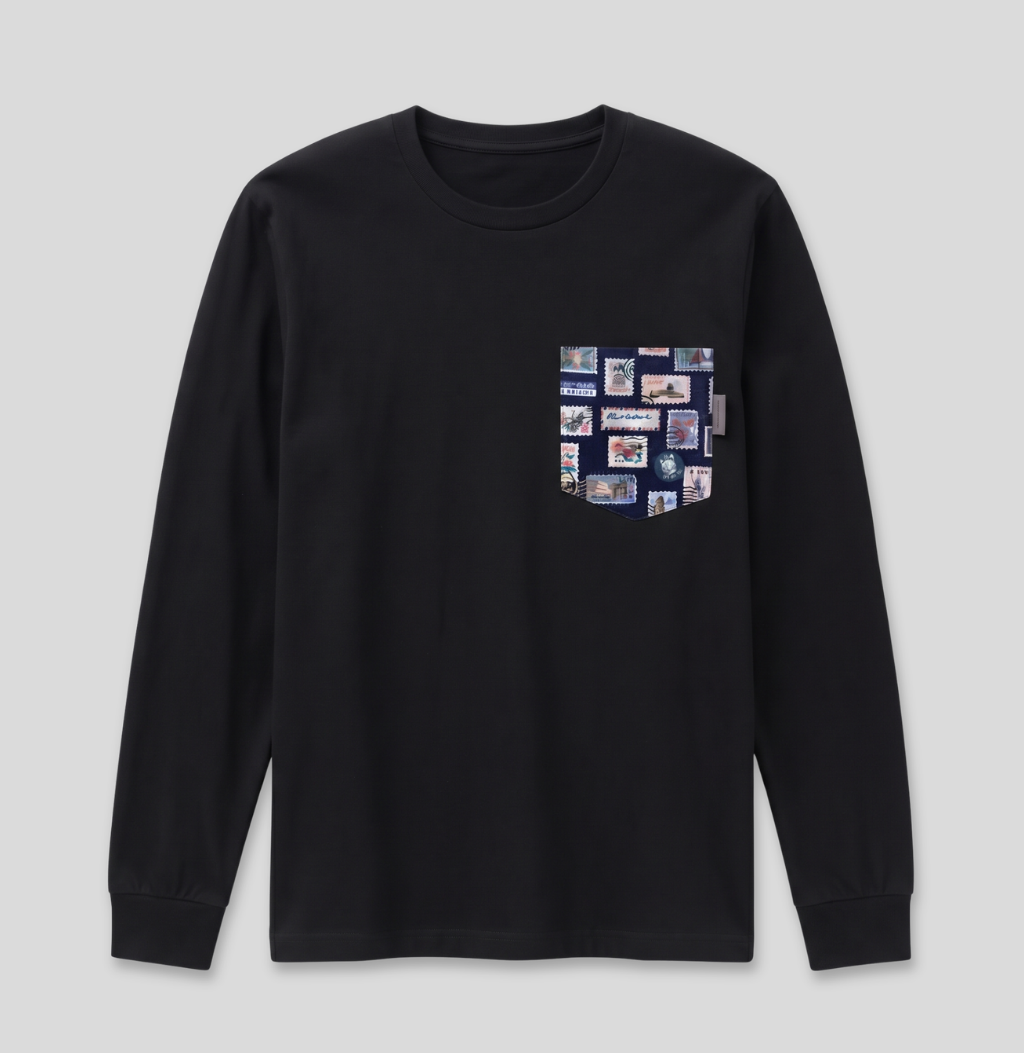 Navy passport stamp fabric pocket on a black long sleeve shirt.