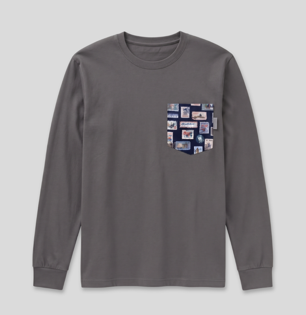 Navy passport stamp fabric pocket on a charcoal long sleeve shirt.
