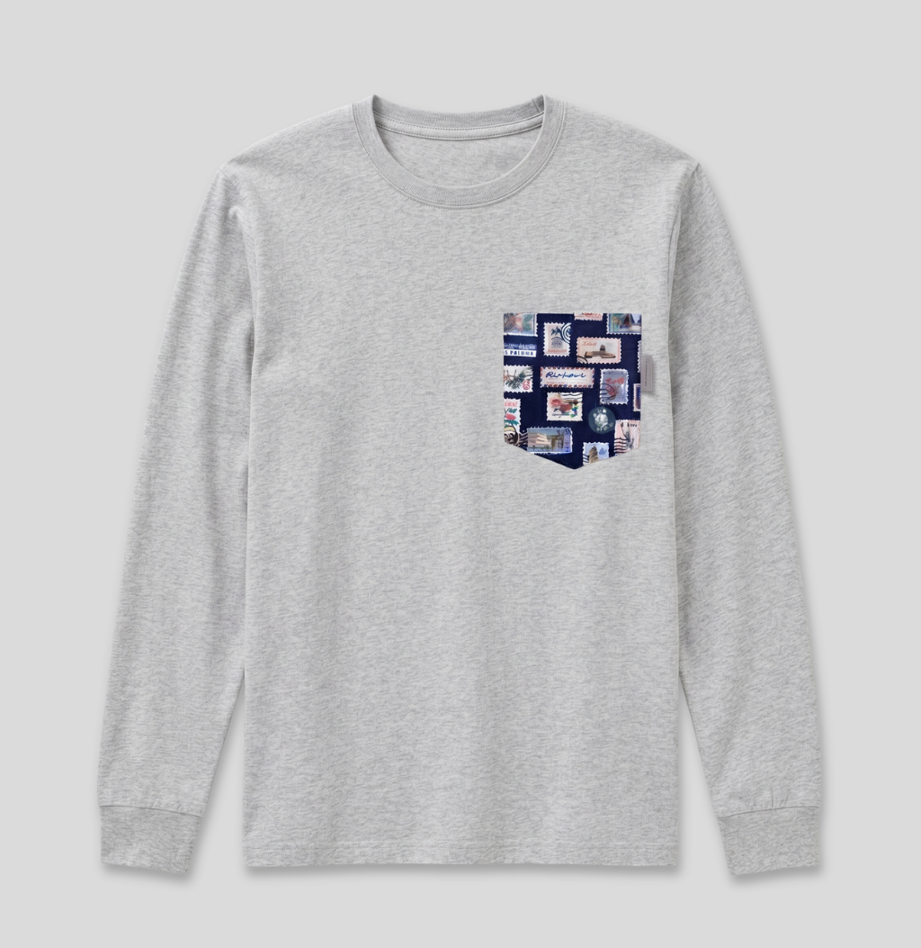 Navy passport stamp fabric pocket on a heather grey long sleeve shirt.