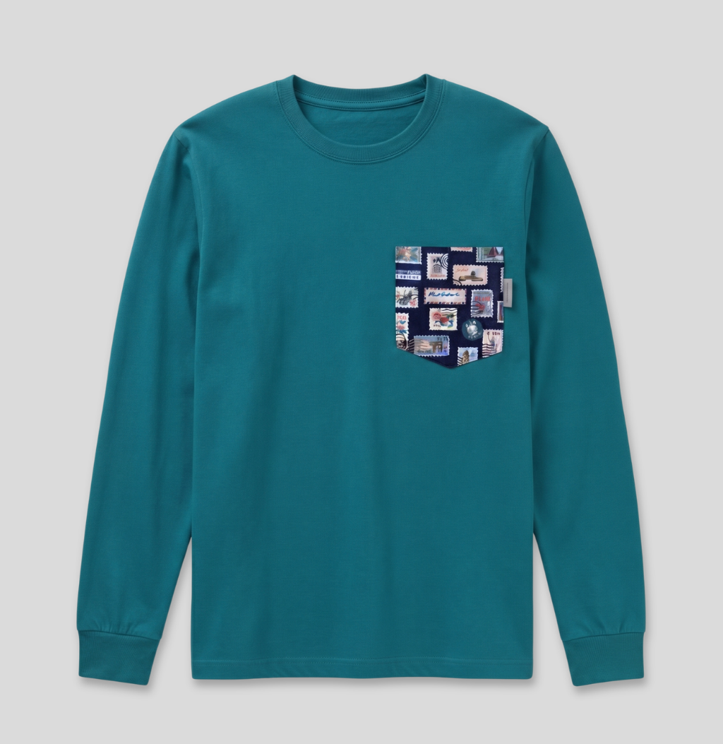 Navy passport stamp fabric pocket on a teal long sleeve shirt.