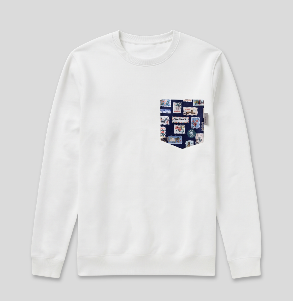Navy passport stamp fabric pocket on a white crew sweatshirt.